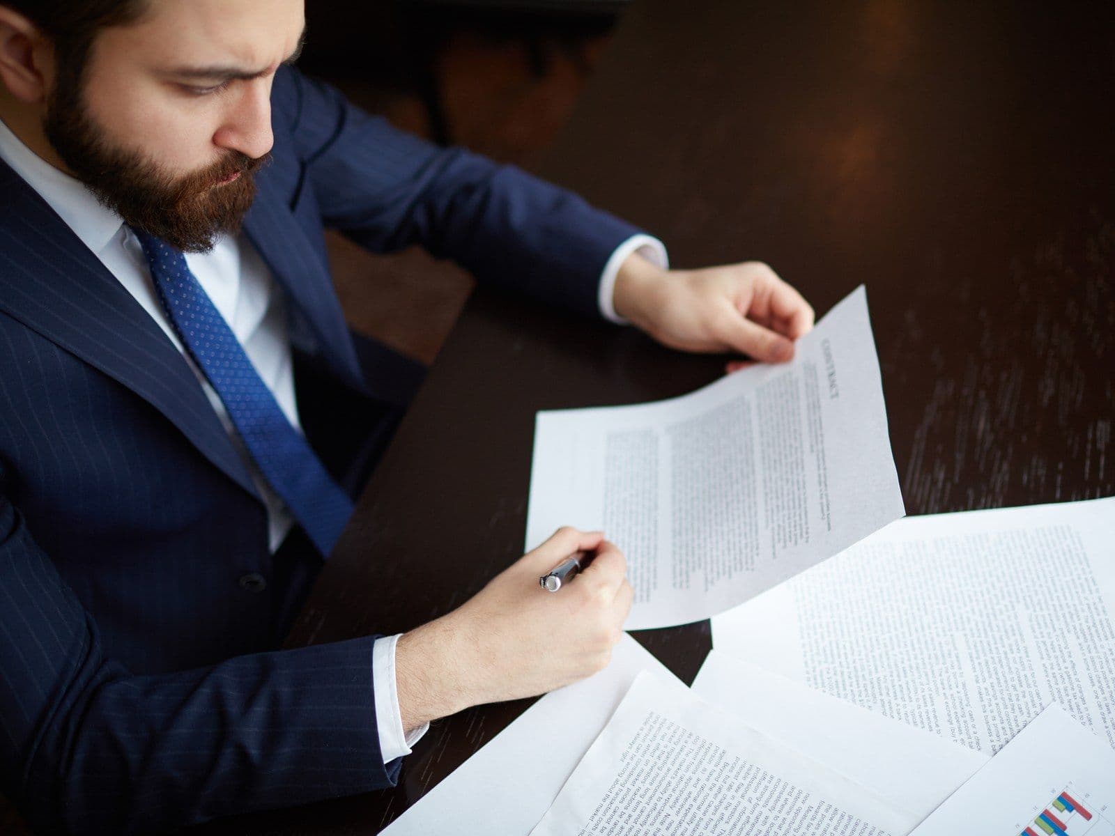 Entrepreneur reviewing shareholder agreements and option grants to clean up the cap table