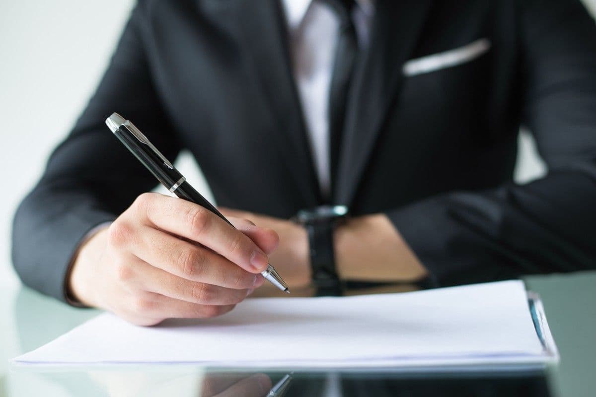 Executive signing a contract within approval limits set by a delegation of authority matrix